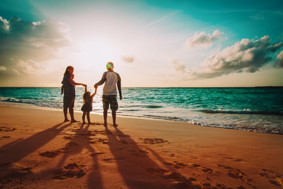 family on the beach at sunset